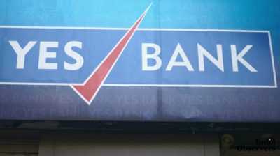 A closeup of the trademark brand logo of Yes bank, in Colaba causeway