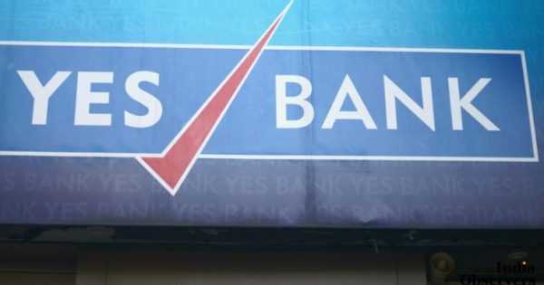 A closeup of the trademark brand logo of Yes bank, in Colaba causeway