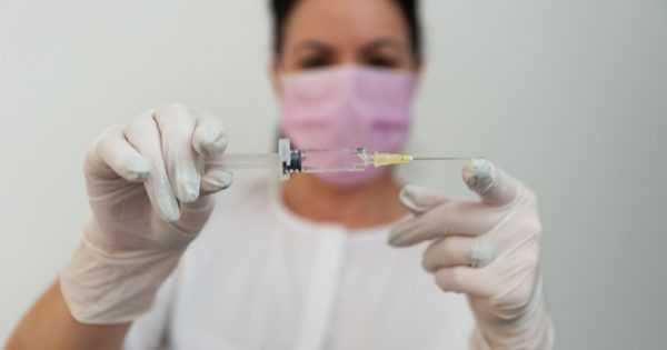 woman doctor syringe needle vaccination
