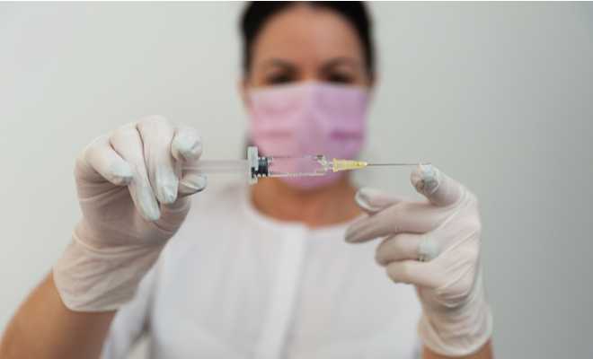 woman doctor syringe needle vaccination