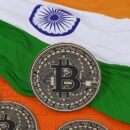 3d rendering of a metallic bitcoin over an indian flag