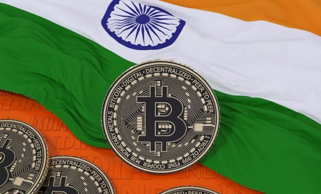 3d rendering of a metallic bitcoin over an indian flag