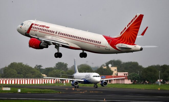 file photo: an air india airbus a320 aircraft takes off as an indigo airlines aircraft waits for clearance at the sardar vallabhbhai patel international airport in ahmedabad