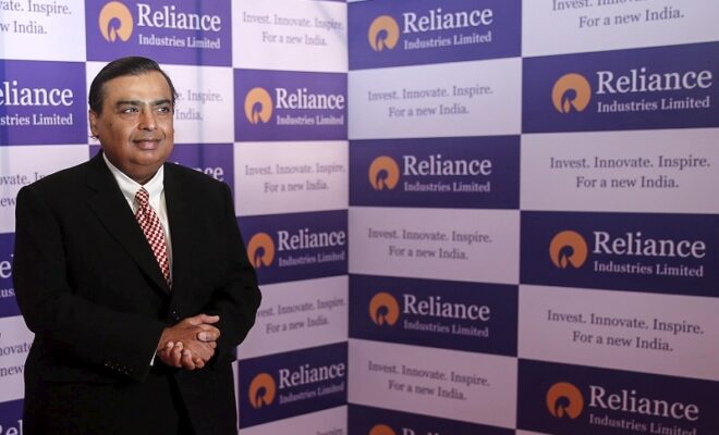 mukesh ambani, chairman of reliance industries limited, poses for photographers before addressing the annual shareholders meeting in mumbai