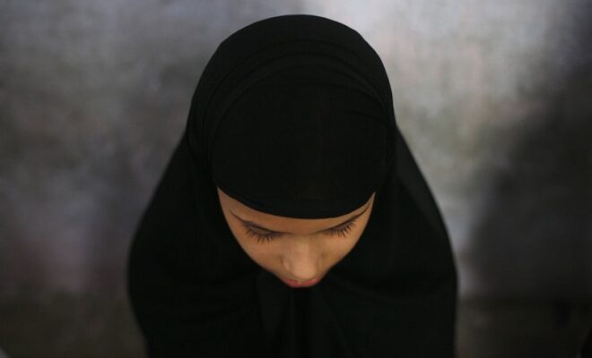 a muslim girl learns to read the koran at a madrassa during ramadan in old quarters of delhi