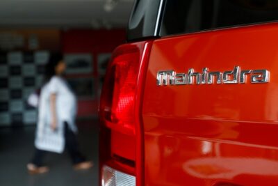 file photo: an employee walks past a mahindra tuv300 car at a showroom in mumbai