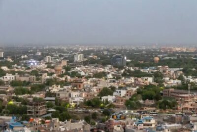 crowded city view with concrete dense houses from mountain peak at dusk