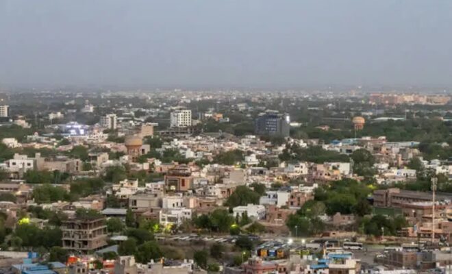 crowded city view with concrete dense houses from mountain peak at dusk